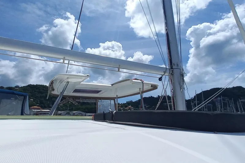 Benetnash II Yacht Photos Pics 2016 Lagoon 42 sailboat deck with mast, under a bright blue sky.