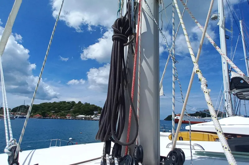 Benetnash II Yacht Photos Pics Sailing ropes on a 2016 Lagoon 42 catamaran with scenic coastal backdrop.