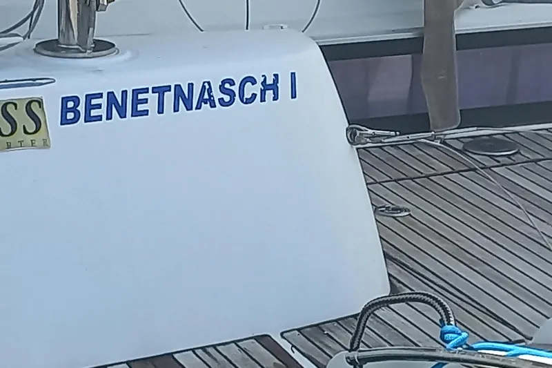 Benetnash II Yacht Photos Pics 2016 Lagoon 42 yacht deck with "BENETNASCHI" nameplate and wooden flooring.