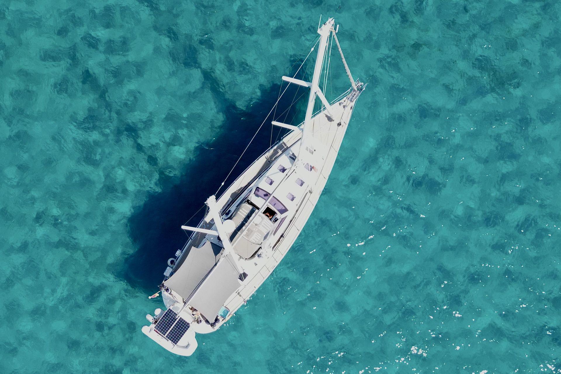 Aerial view of Amel 55 yacht on turquoise water, 2015 model.
