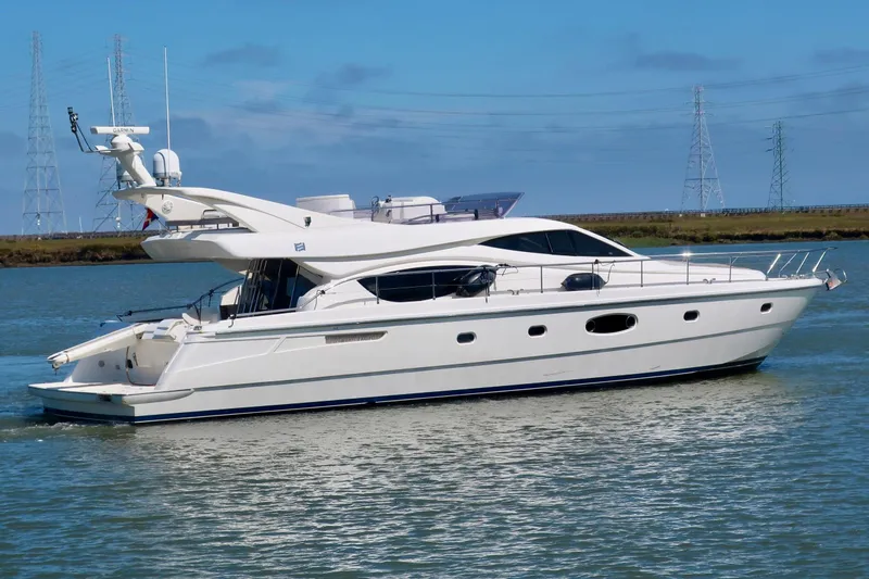Mi Amore Yacht Photos Pics 2006 Ferretti Yachts 550 cruising on a calm waterway, showcasing sleek design and luxury.