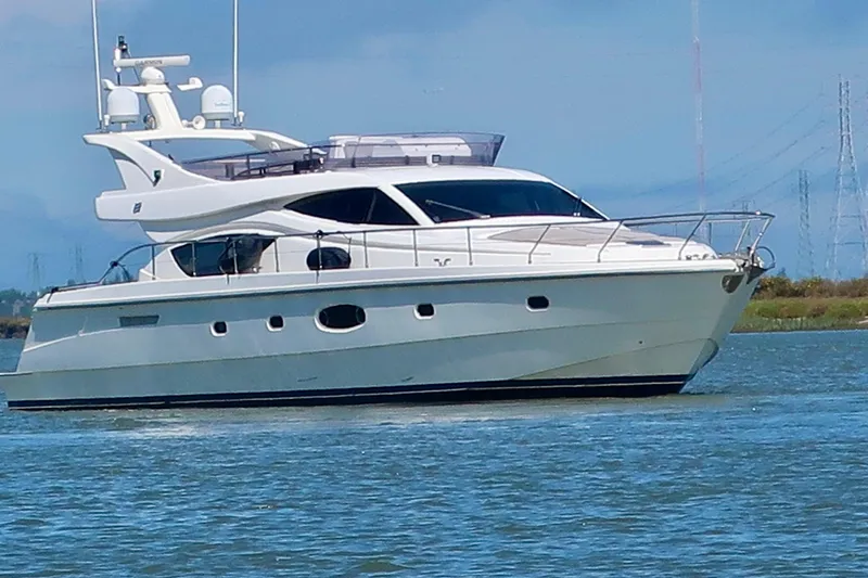 Mi Amore Yacht Photos Pics 2006 Ferretti Yachts 550 cruising on calm waters under a clear blue sky.