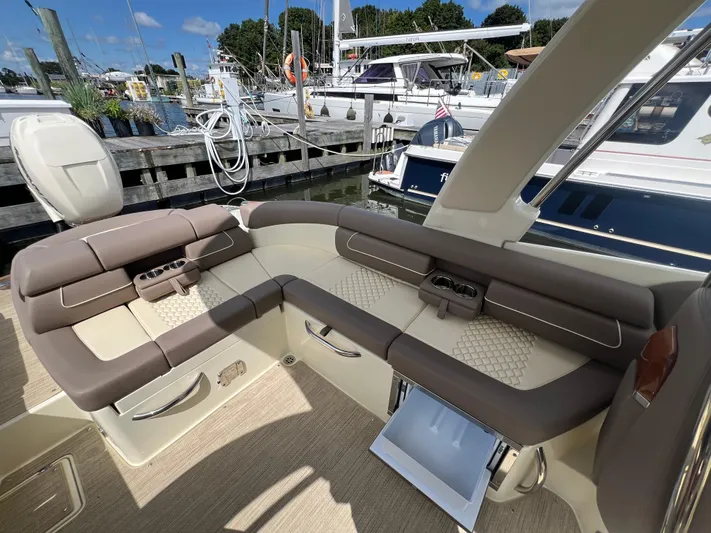  Yacht Photos Pics 2023 Chris-Craft Launch 28 GT luxury boat interior with plush seating at marina.