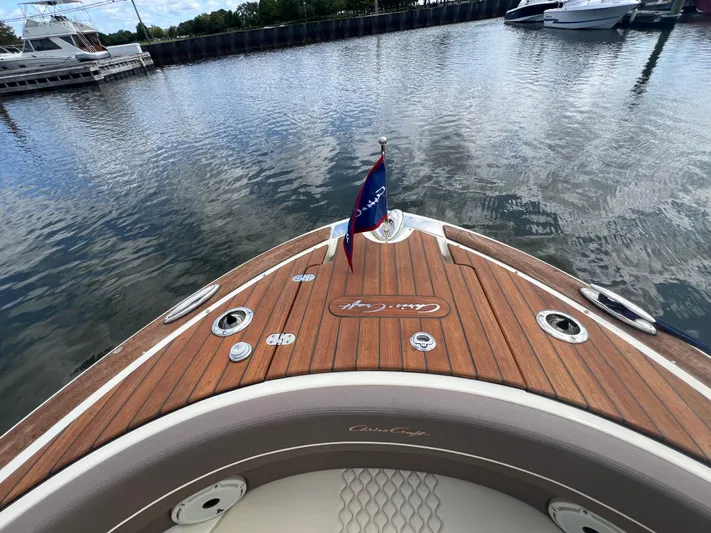  Yacht Photos Pics 2023 Chris-Craft Launch 28 GT boat with wooden deck, docked in a marina.