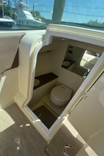  Yacht Photos Pics 2023 Chris-Craft Launch 28 GT boat interior with compact bathroom.