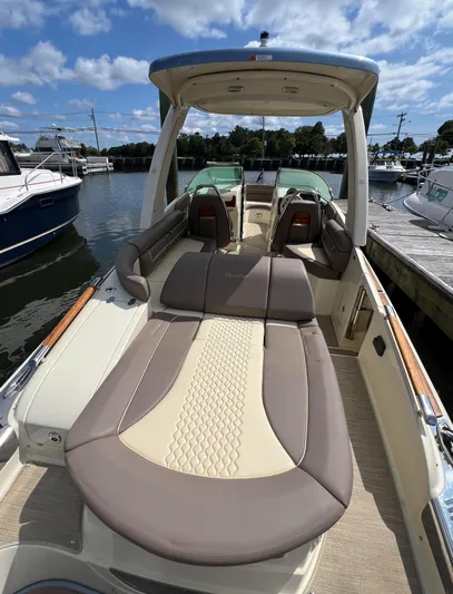  Yacht Photos Pics 2023 Chris-Craft Launch 28 GT boat with luxurious seating, docked at a marina.