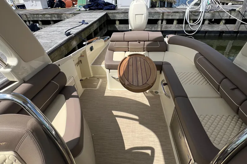  Yacht Photos Pics Luxurious interior of 2023 Chris-Craft Launch 28 GT boat with elegant seating and wooden accents.
