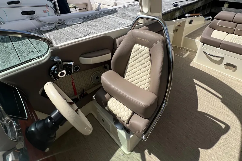  Yacht Photos Pics 2023 Chris-Craft Launch 28 GT interior with luxurious seating and steering wheel.