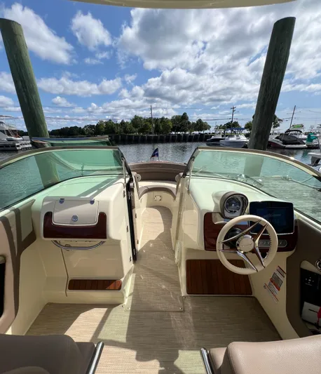  Yacht Photos Pics 2023 Chris-Craft Launch 28 GT boat interior with steering wheel, dashboard, and waterfront view.