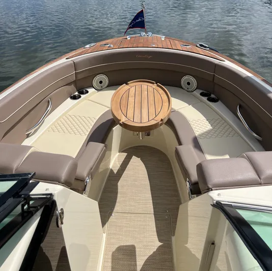  Yacht Photos Pics 2023 Chris-Craft Launch 28 GT boat interior with elegant seating and wooden table.