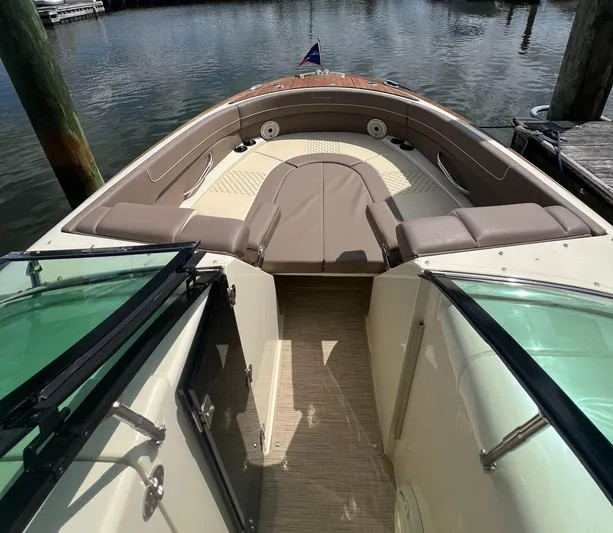  Yacht Photos Pics 2023 Chris-Craft Launch 28 GT boat interior with seating, docked on calm water.