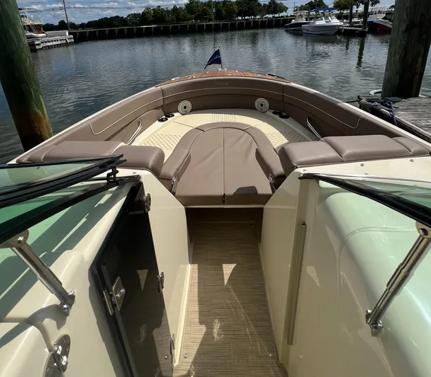  Yacht Photos Pics 2023 Chris-Craft Launch 28 GT boat interior with seating, docked by the water.