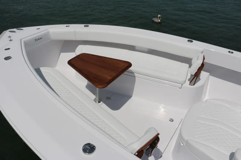  Yacht Photos Pics Luxurious 2026 Bahama 41 GT boat interior with white seating and wooden table.