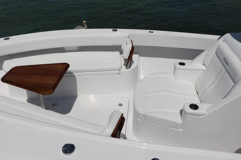  Yacht Photos Pics Luxurious seating area on 2026 Bahama 41 GT boat with white upholstery and wooden table.