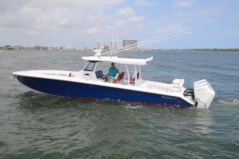  Yacht Photos Pics 2026 Bahama 41 GT boat cruising on open water with city skyline in background.