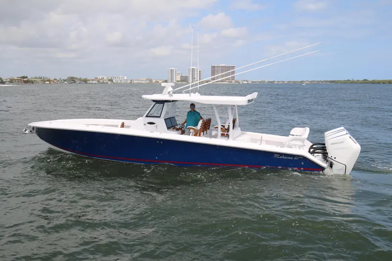  Yacht Photos Pics 2026 Bahama 41 GT boat cruising on open water with city skyline in background.