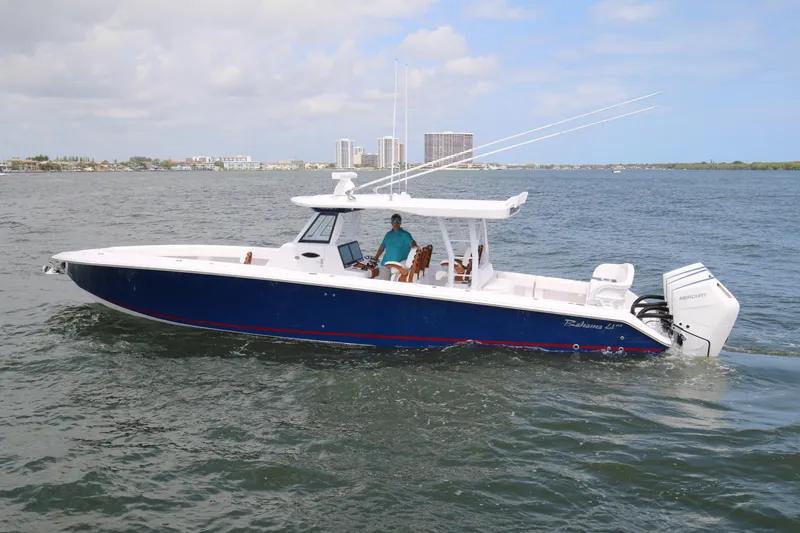  Yacht Photos Pics 2026 Bahama 41 GT boat cruising on open water with city skyline in background.
