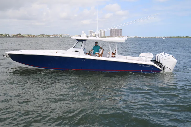  Yacht Photos Pics 2026 Bahama 41 GT boat cruising on open water with triple outboard engines.