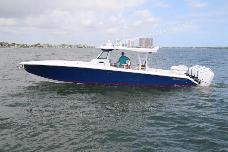  Yacht Photos Pics 2026 Bahama 41 GT boat cruising on open water with triple Mercury engines.