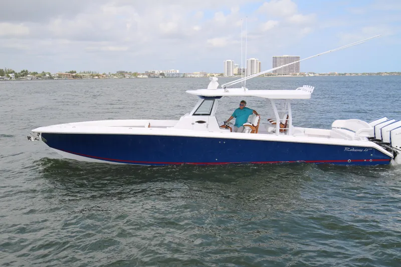  Yacht Photos Pics 2026 Bahama 41 GT boat cruising on water with city skyline in background.