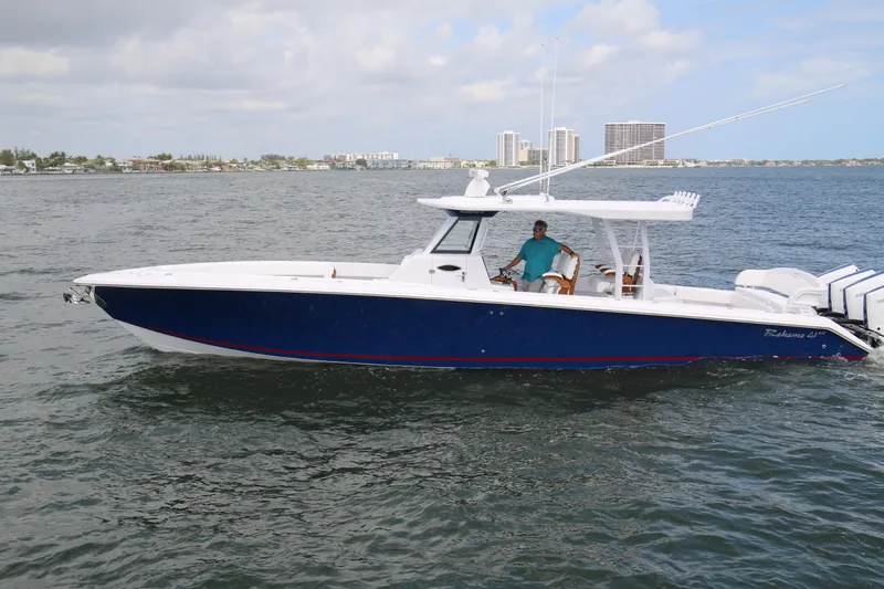  Yacht Photos Pics 2026 Bahama 41 GT boat cruising on open water with city skyline in background.