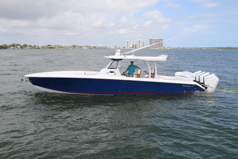  Yacht Photos Pics 2026 Bahama 41 GT boat cruising on open water with city skyline in background.