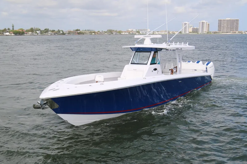  Yacht Photos Pics 2026 Bahama 41 GT boat cruising on open water, featuring sleek blue and white design.