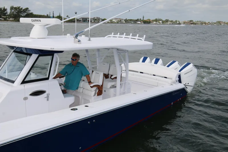  Yacht Photos Pics 2026 Bahama 41 GT boat cruising on water with Garmin navigation system.