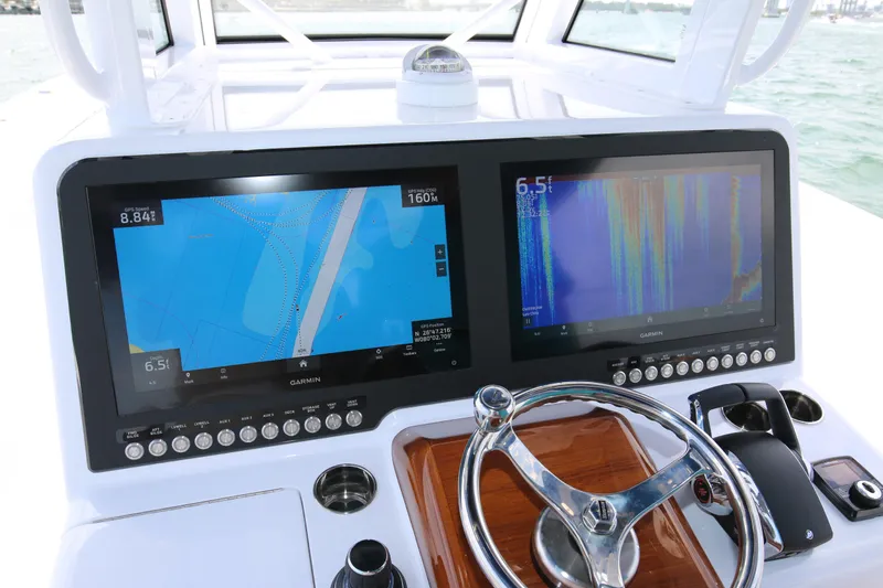  Yacht Photos Pics 2026 Bahama 41 GT boat dashboard with dual Garmin navigation screens and steering wheel.