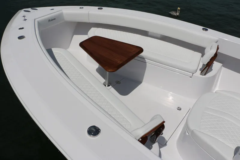  Yacht Photos Pics Luxury seating area on 2026 Bahama 41 GT boat with wooden table and white cushions.