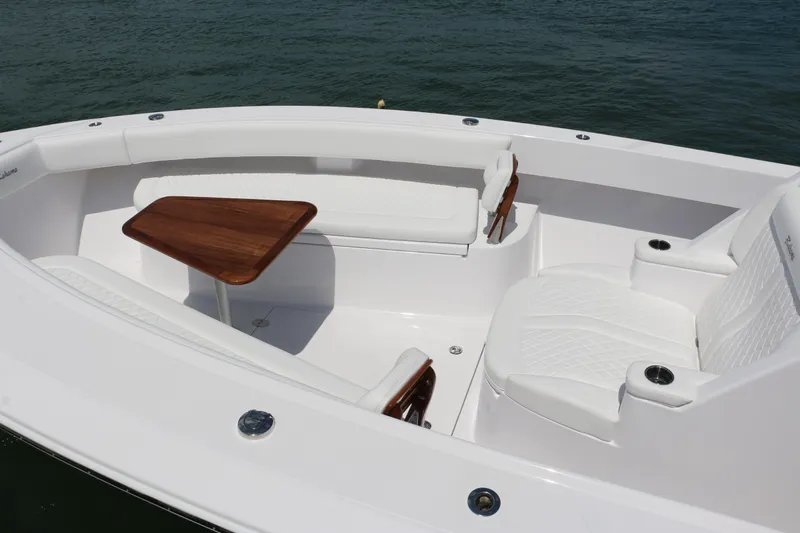  Yacht Photos Pics Luxurious seating area on 2026 Bahama 41 GT boat with wooden table and white cushions.