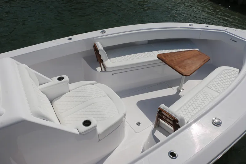  Yacht Photos Pics Luxurious seating area on 2026 Bahama 41 GT boat with elegant white upholstery and wooden table.
