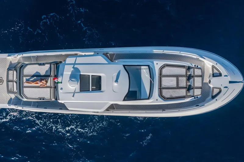  Yacht Photos Pics Aerial view of 2027 Canados Gladiator 571 Blade yacht cruising on blue ocean.