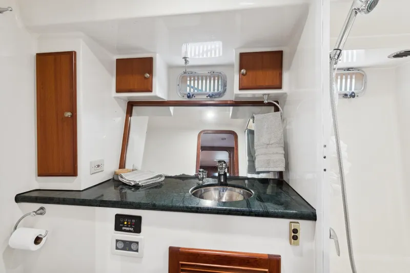Seabatical Yacht Photos Pics Luxurious bathroom in 2008 North Pacific 43 Pilothouse yacht with modern fixtures and wood accents.