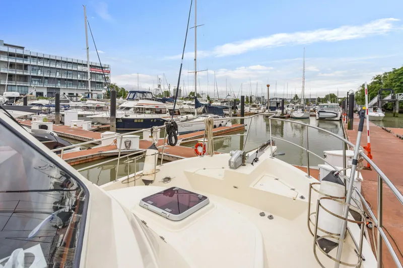 Seabatical Yacht Photos Pics 2008 North Pacific 43 Pilothouse yacht docked at a marina with other boats.