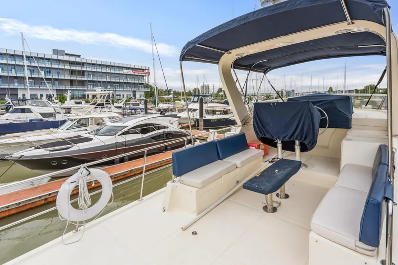 Seabatical Yacht Photos Pics 2008 North Pacific 43 Pilothouse yacht docked at marina, featuring spacious seating and covered helm.
