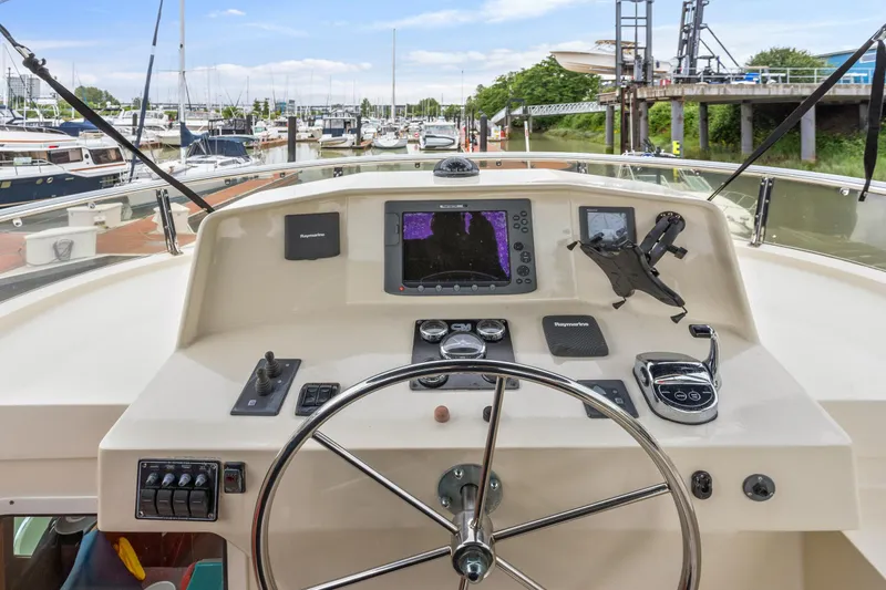 Seabatical Yacht Photos Pics Pilothouse of 2008 North Pacific 43, featuring navigation equipment and steering wheel at marina.