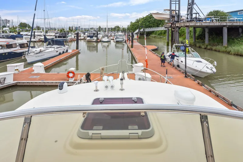 Seabatical Yacht Photos Pics View from North Pacific 43 Pilothouse yacht in marina, 2008 model, docked among other boats.