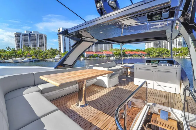 Rani Yacht Photos Pics Luxurious 2023 Sunseeker Manhattan 68 Pacific yacht deck with modern seating and scenic marina view.