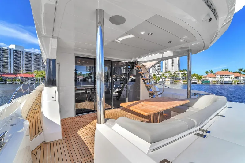 Rani Yacht Photos Pics Luxurious 2023 Sunseeker Manhattan 68 Pacific yacht with elegant outdoor seating and scenic waterfront view.