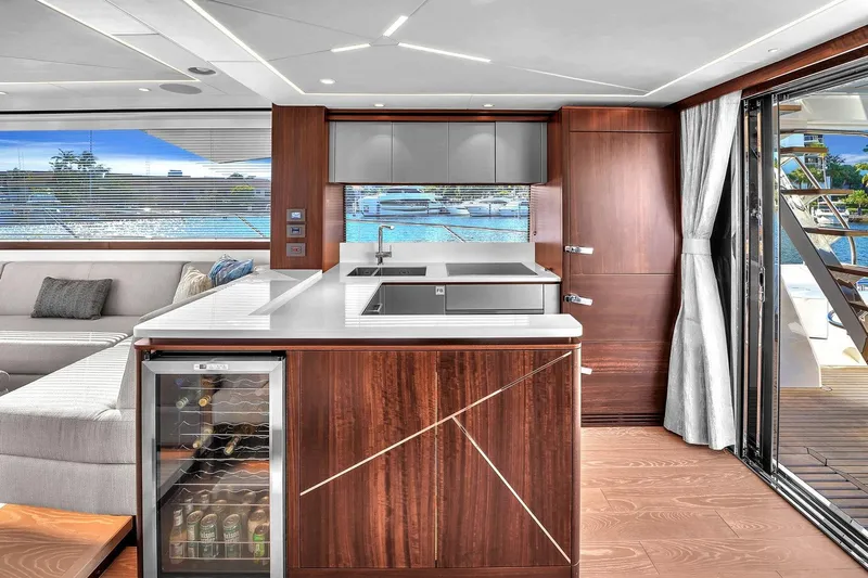 Rani Yacht Photos Pics Luxurious interior of 2023 Sunseeker Manhattan 68 Pacific yacht with modern kitchen and scenic view.