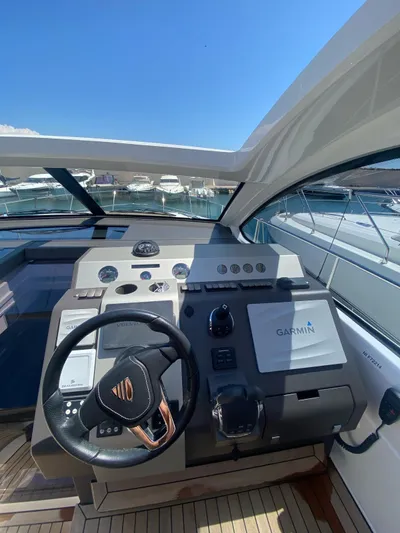  Yacht Photos Pics 2018 Fairline Targa 48 Open yacht helm with Garmin navigation system, docked under clear blue sky.