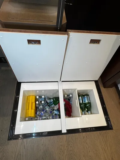  Yacht Photos Pics Built-in cooler storage on 2018 Fairline Targa 48 Open yacht, stocked with beverages.