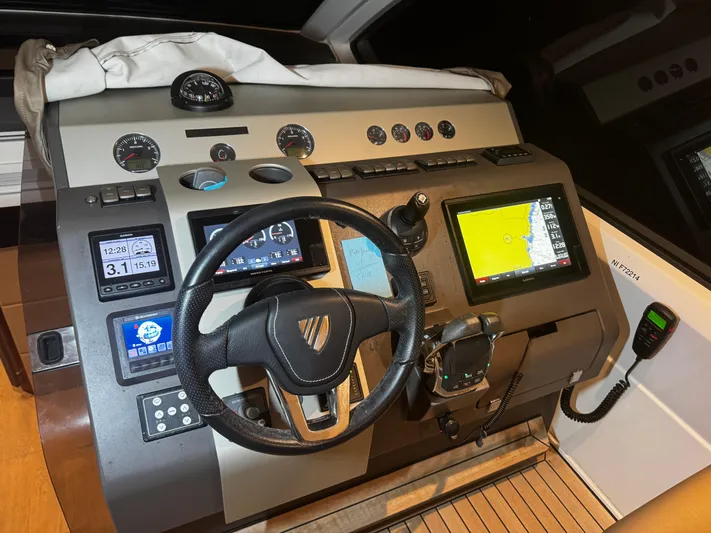  Yacht Photos Pics Control panel of a 2018 Fairline Targa 48 Open yacht with navigation screens and instruments.