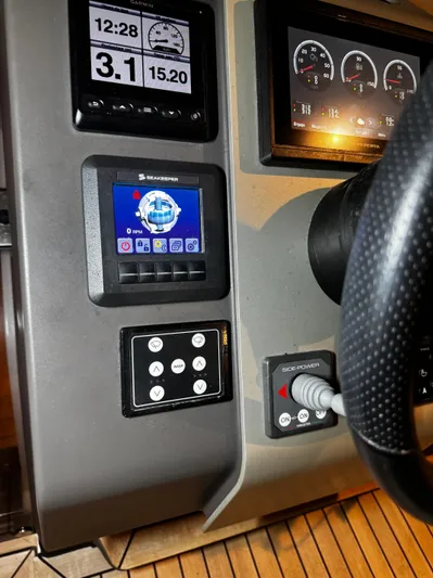  Yacht Photos Pics Control panel of 2018 Fairline Targa 48 Open yacht with digital displays and steering wheel.