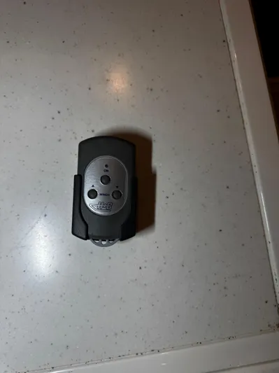  Yacht Photos Pics Remote control for 2018 Fairline Targa 48 Open on a white speckled surface.