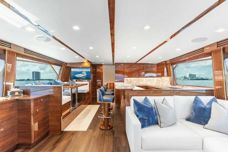 Team Harvey Yacht Photos Pics Luxurious interior of 2026 Viking 82 Convertible yacht with elegant wood finishes and plush seating.