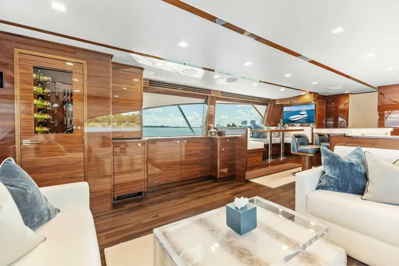 Team Harvey Yacht Photos Pics Luxurious interior of 2026 Viking 82 Convertible yacht with elegant wood finishes and plush seating.