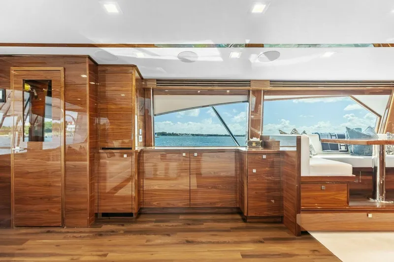 Team Harvey Yacht Photos Pics Luxurious interior of 2026 Viking 82 Convertible yacht with wood finishes and ocean view.