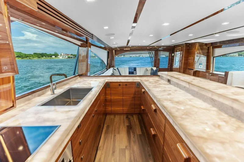Team Harvey Yacht Photos Pics Luxurious interior of 2026 Viking 82 Convertible yacht with elegant wood finishes and ocean view.